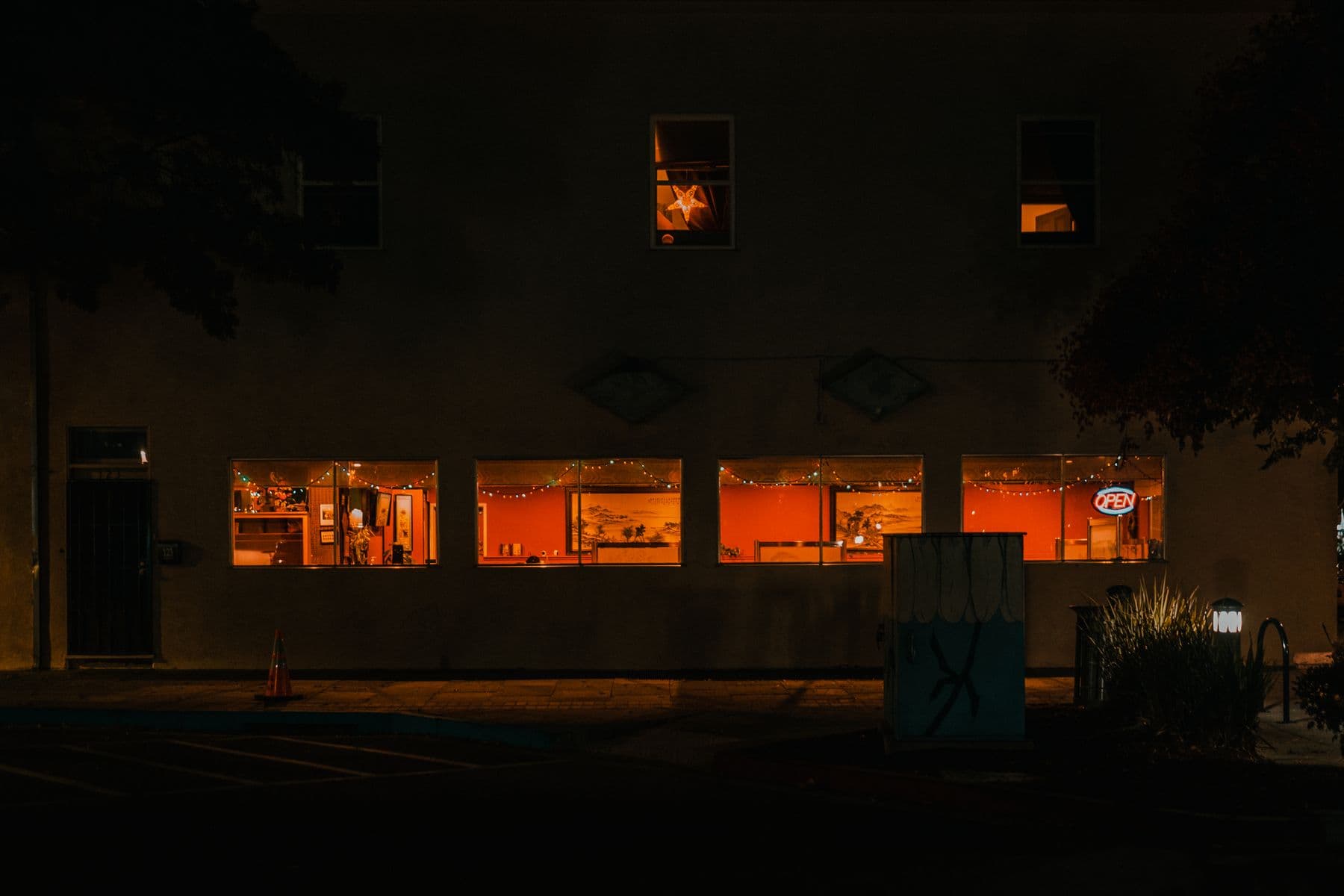 A small business lit up from inside, seen from the street at night